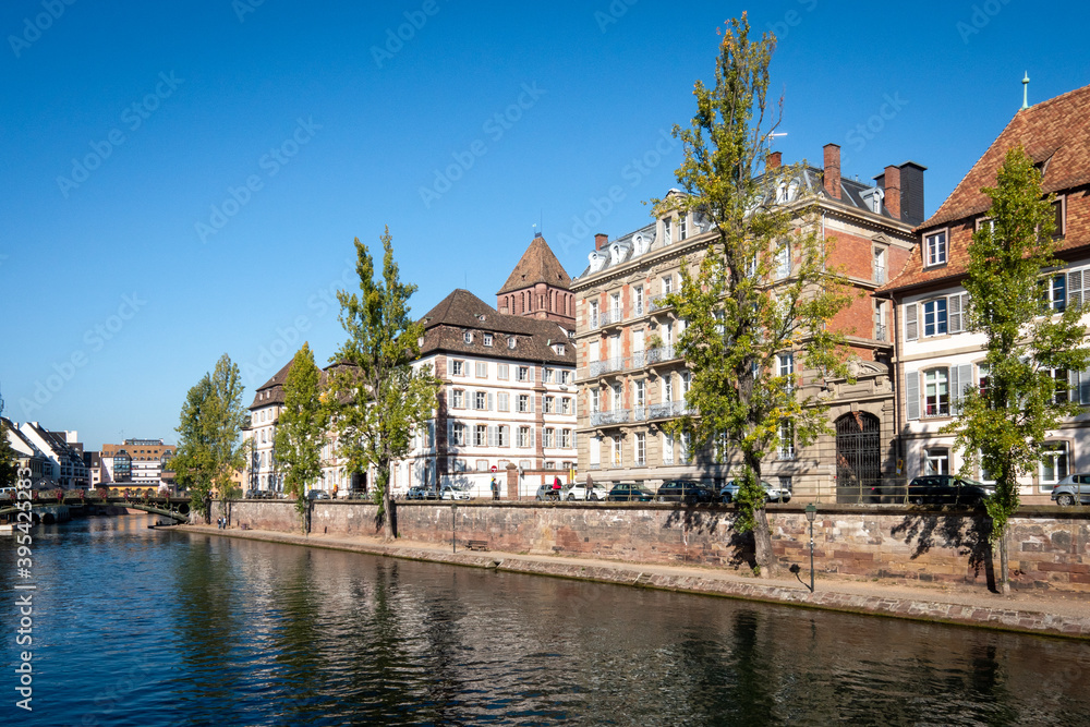 View on the quays of the island of Strasbourg. The city is located in the east of France, in the region of Alsace. Photographed on a sunny day. Blue sky.