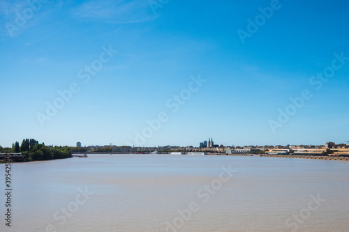View of the Garonne River in Bordeaux, France. Sunny day, blue sky, summer.