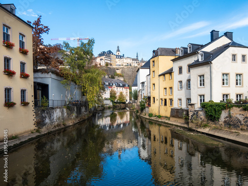 Canal in the old center of Luxembourg city in Europe. Reflection on the water. Sunny day, blue sky, autumn.