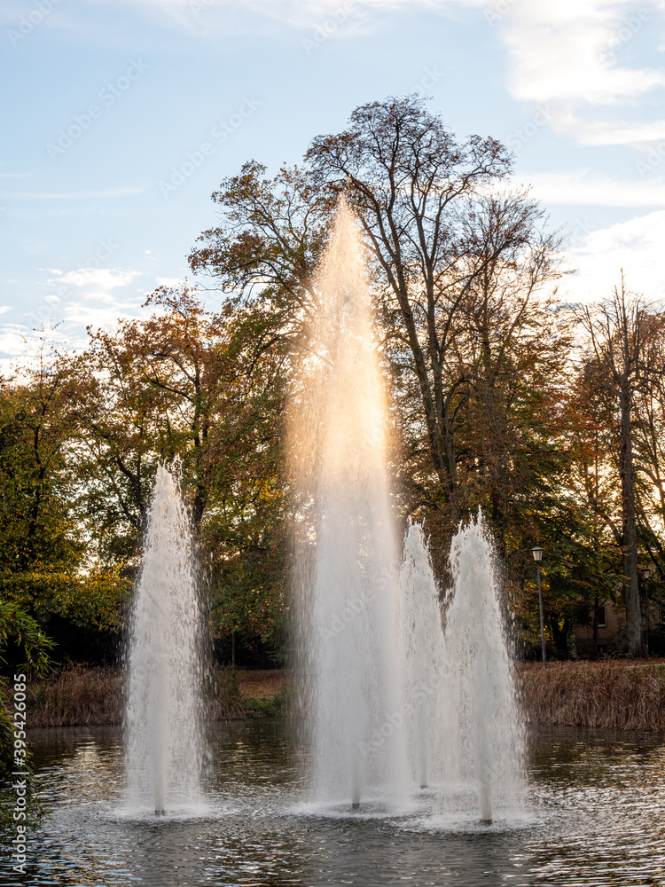 Fountain in a park in Luxembourg city, in Europe. Photographed during autumn. Evening light on the water.