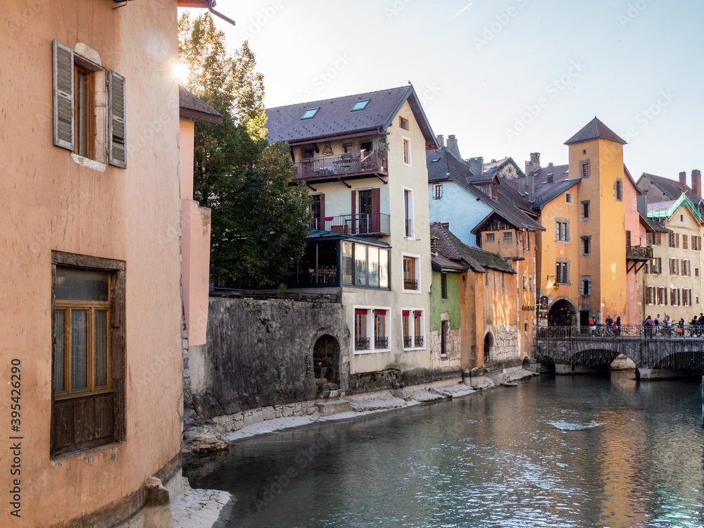 View on the canal in the city of Annecy, Haute-savoie, France. Flowers in the foreground. Old town, colorful buildings.