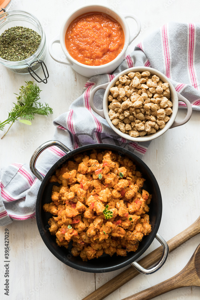 Healthy vegan scene composed of casseroles of bolognese soya meat, raw chunks of soy and tomato sauce. Healthy vegan scene composed of casseroles of bolognese soya meat, raw chunks of soy and tomato sauce.