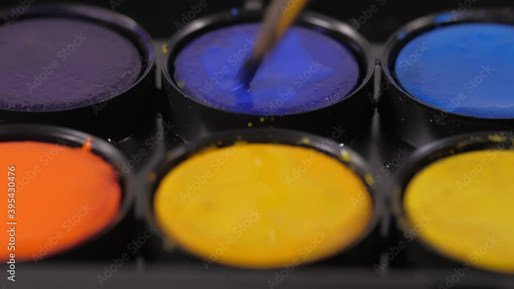artist painter mixing water and blue watercolor with brush 4k artist painter mixing water and blue watercolor with brush 4k