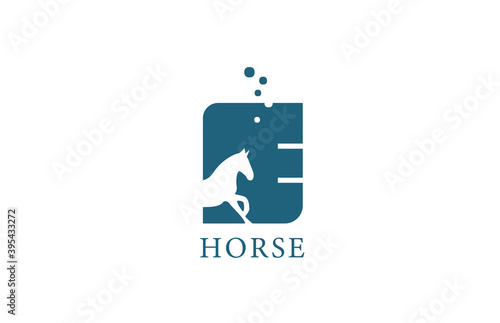 E blue white horse alphabet letter logo icon with stallion shape inside. Creative design for company and business