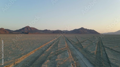 Aerial view Ascending moving forward shot, Scenic view of the Bonneville Salt Flats in Utah, Graham peaks in the background. photo