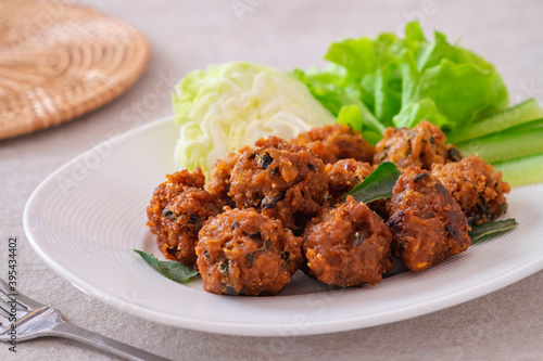 Deep fried spicy minced pork served with vegetable on plate, Thai food