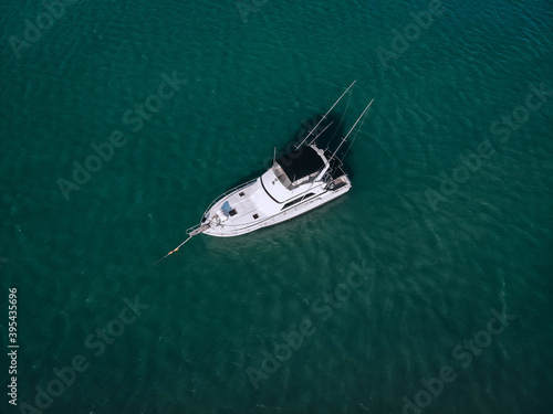 aerial View Of little yacht with black sail At The Andaman sea. Phuket. Thailand