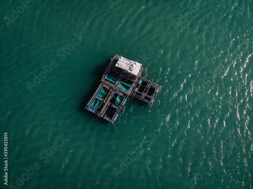 Aerial drone top view photo of large fishing boat cruising with  fishing net to catch fish © Semachkovsky 