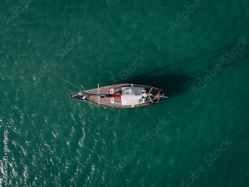 Aerial view of a sailing yacht in the turquoise water of the Andaman sea. Phuket. Thailand