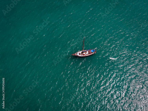 Aerial view of a  sailing yacht in the turquoise water of the Andaman sea. Phuket. Thailand © Semachkovsky 