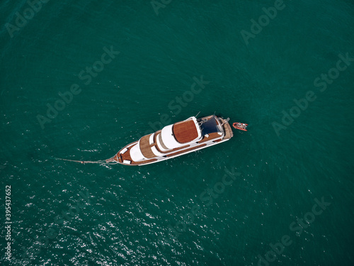 Aerial picture of an isolated yacht with brown wooden design in the sea © Semachkovsky 