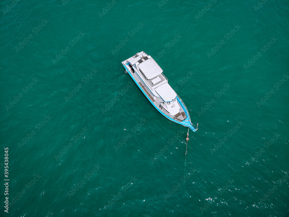 Aerial photo of an isolated luxury white  yacht design in the sea.