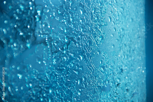 Frozen pattern. Melting ice on the window.