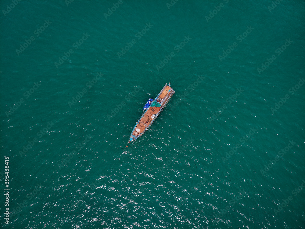 Aerial view from drone, Thai fishing boat used as a vehicle for finding fish in the sea, Thailand .