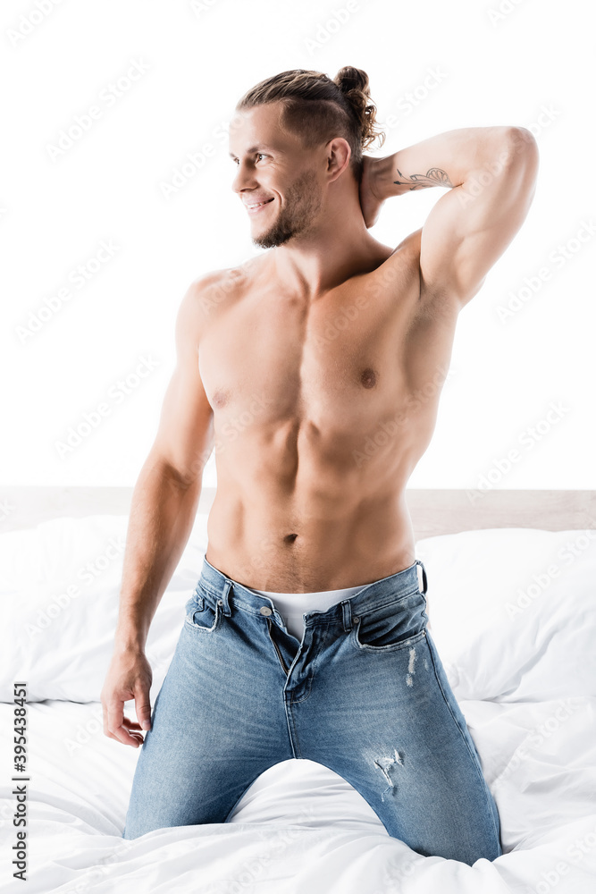 sexy shirtless man in jeans posing in bed isolated on white sexy shirtless man in jeans posing in bed isolated on white