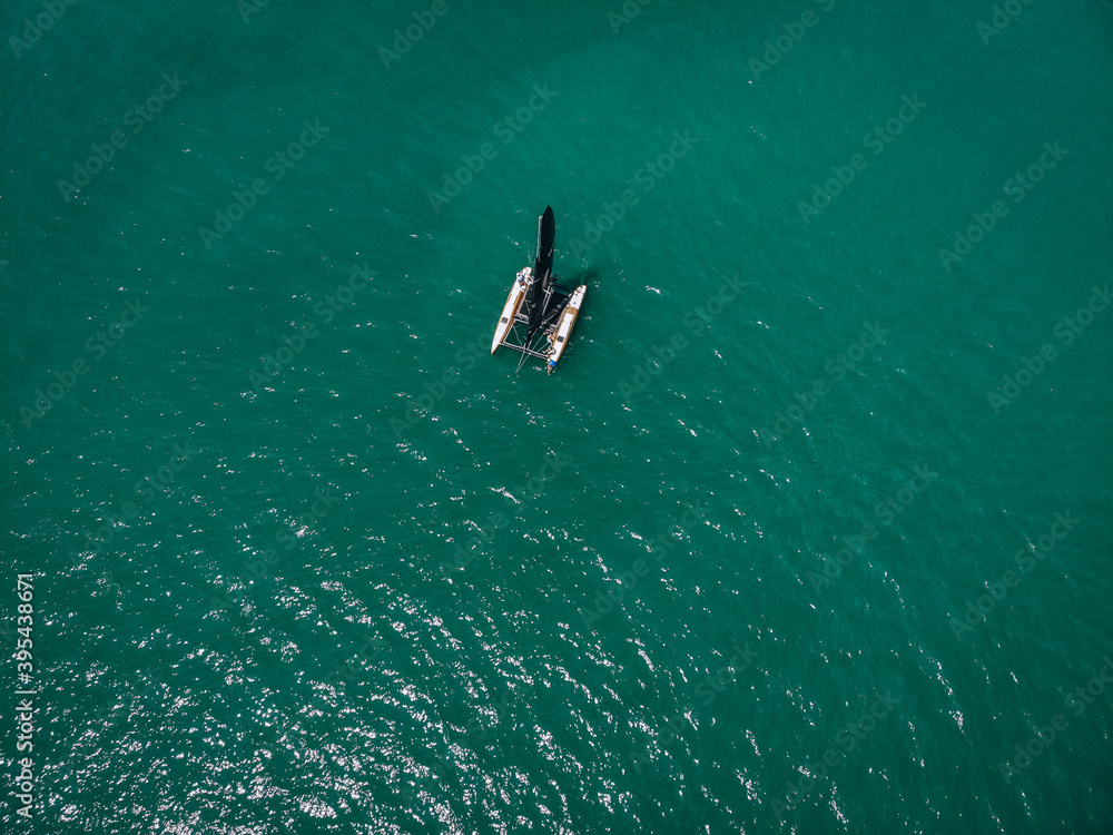 aerial View Of   little yacht with black sail  At The Andaman sea. Phuket. Thailand