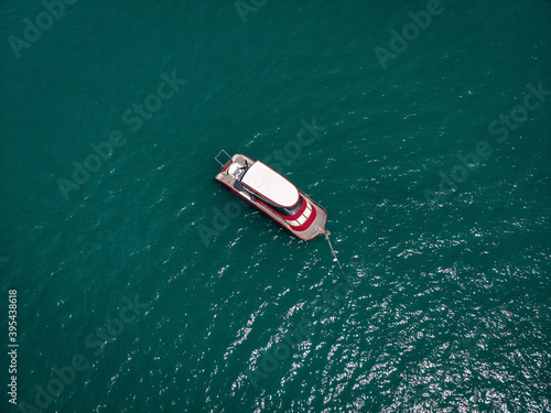 Aerial picture of an isolated yacht with red design in the sea © Semachkovsky 