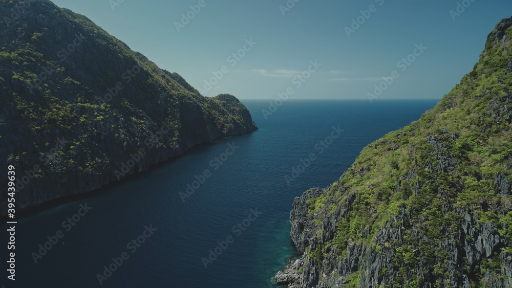 Epic seascape at ocean bay aerial. Greenery mount ranges with tropical forest and plants. Green tropic mountain island nature of sea coast water at soft light. Cinematic drone shot panorama view