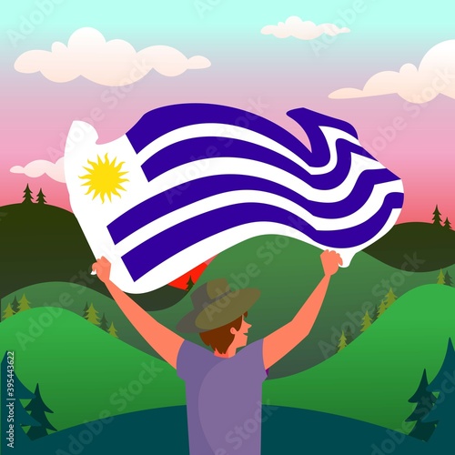 Personaje sujetando bandera de Uruguay con atardecer y campo de fondo photo