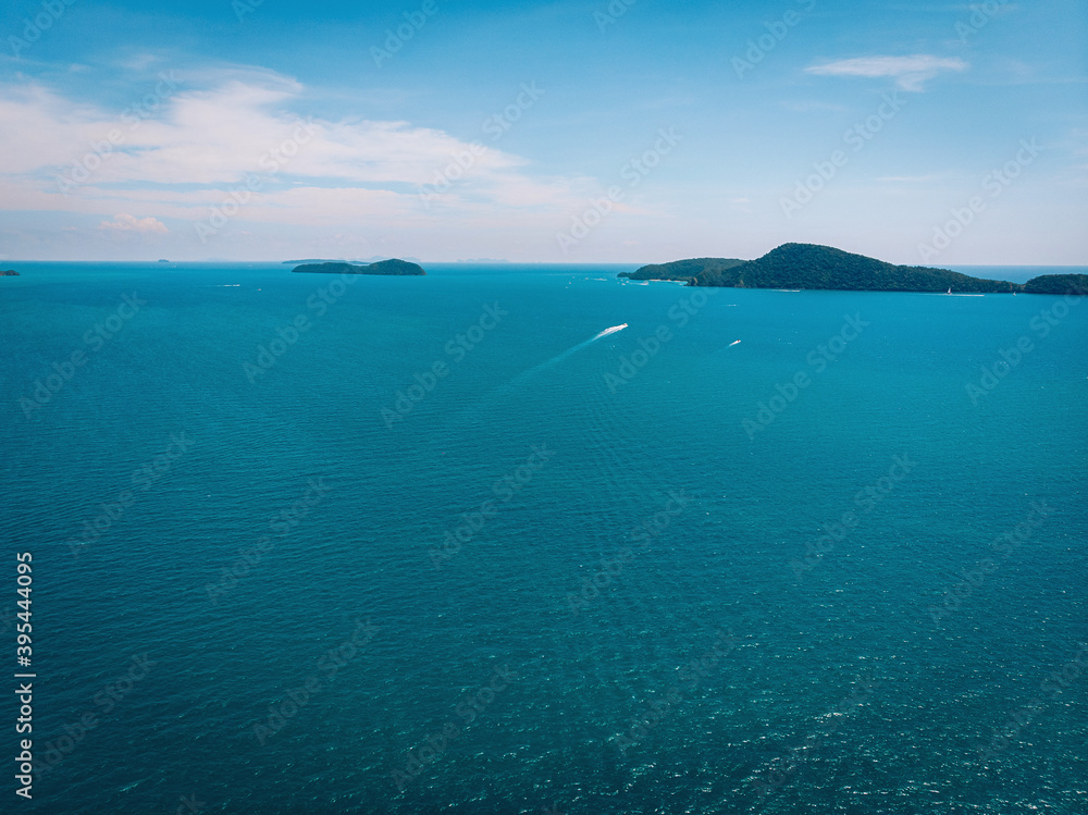 Top view aerial photo from flying drone of an amazing seascape with paradise beach and sea with turquoise water. Summer vacation holidays in Thailand. Perfect website background with copy space area