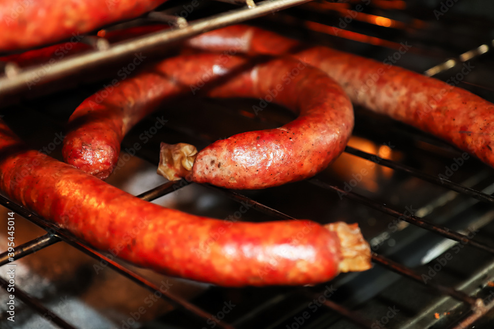 Racks of ham sausages drying in an oven after being bloomed Racks of ham sausages drying in an oven after being bloomed