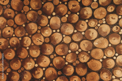 A pile of oak trunks of different sizes  wooden background