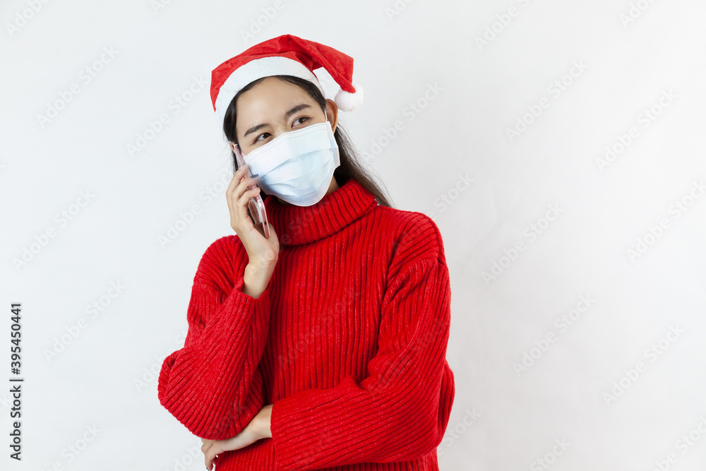 asia woman in a Santa hat in a protective mask, in a red sweater,holding mobile phone on white background
asia woman in a Santa hat in a protective mask, in a red sweater,holding mobile phone on white background