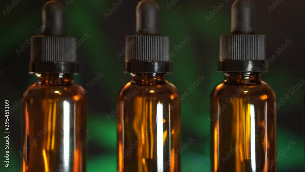 CBD oil in laboratory with marijuana background, hemp oil, essential oils, and alternative medicine CBD oil in laboratory with marijuana background, hemp oil, essential oils, and alternative medicine