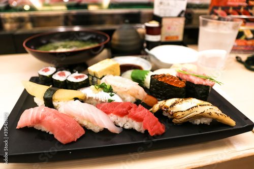 Mixed sushi set on a black plate, Japanese food.
