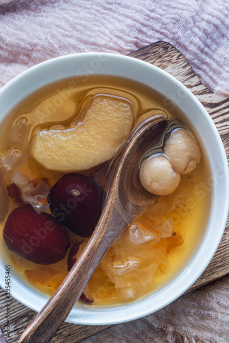 Peach Gum Dessert, Chinese Traditional Refreshment with Peach Gum, Red Dates, Snow Fungus,  peach sliced, dry seedless longan and Rock Sugar photo