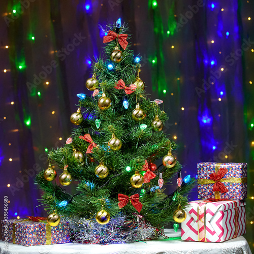 Christmas card with gifts and beautiful decorated Christmas tree