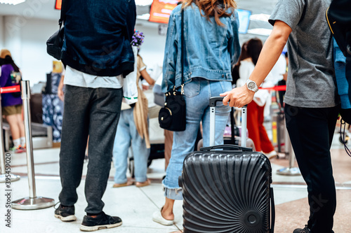 people waiting for check in at airport. A man and luggage at the airport terminal.