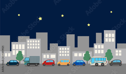 自動車が走る夜の都市のベクターイラスト