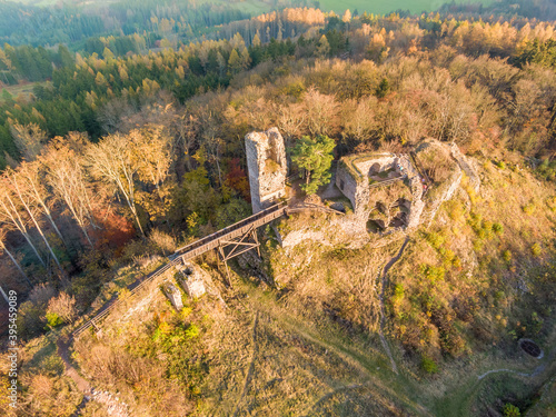 Aerial drone view of ruined castle Zubstejn standing on hill, Czech Republic. Autumn day during the sunset. One of biggest ruins in Czechia. Also known as Zuberstein or Zubstein.