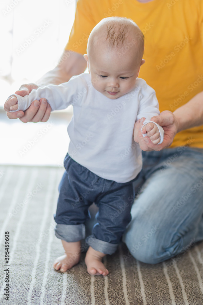 Happy father playing with adorable baby in the room at home. Happy father playing with adorable baby in the room at home.