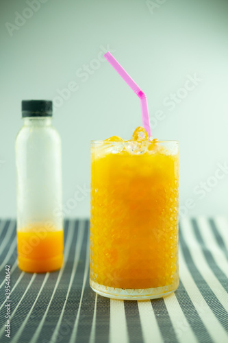One fresh orange juice bottle with tasty drink
