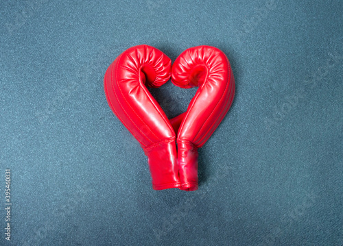 Gym background and fitness equipment and valentine concept. Boxing glove in shape of heart.