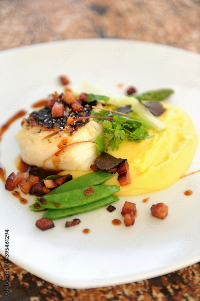 Fish fillet with mashed potatoes, bacon and mange tout Fish fillet with mashed potatoes, bacon and mange tout