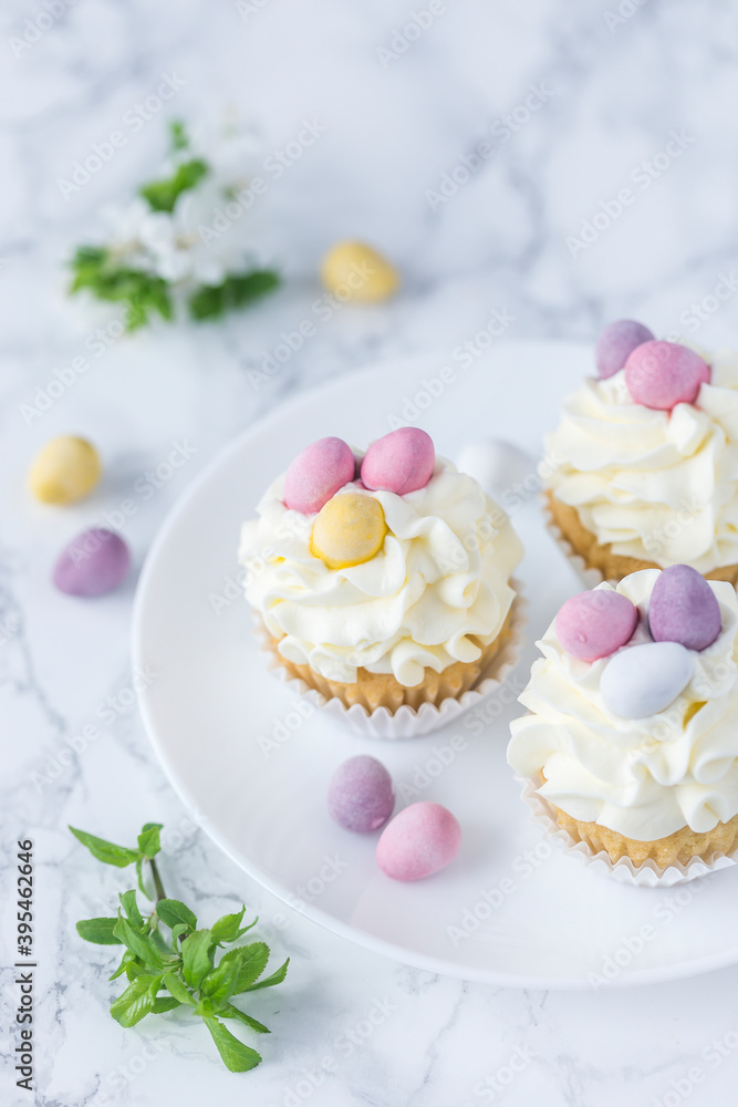 Cupcakes with creamy frosting and sugar eggs for Easter Cupcakes with creamy frosting and sugar eggs for Easter