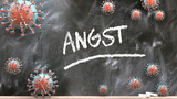 Angst and covid virus - pandemic turmoil and Angst pictured as corona viruses attacking a school blackboard with a written word Angst, 3d illustration
