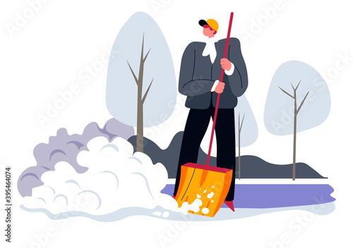 Man cleaning backyard from snow with wooden shovel