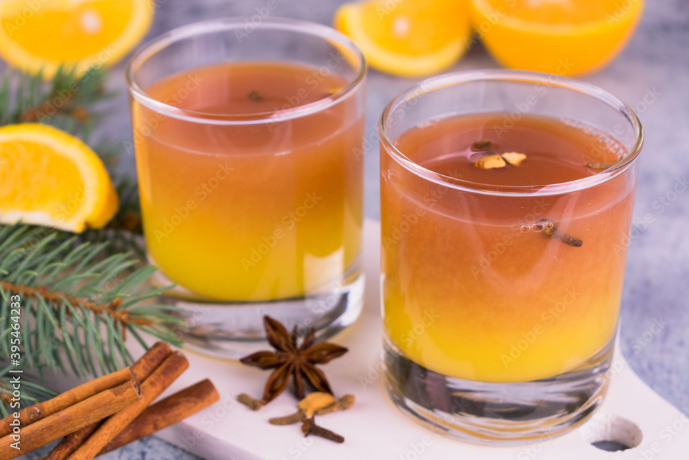 Mulled wine with orange juice and spices is decorated with a New Year's composition. Mulled wine with orange juice and spices is decorated with a New Year's composition.