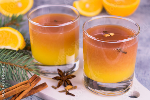 Mulled wine with orange juice and spices is decorated with a New Year's composition.
