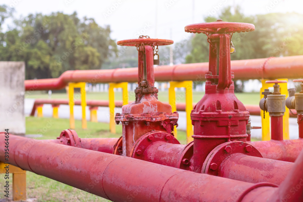 Red iron fire pipe and big valve for water set line up in a long row. It is the big system of Fire management Red iron fire pipe and big valve for water set line up in a long row. It is the big system of Fire management