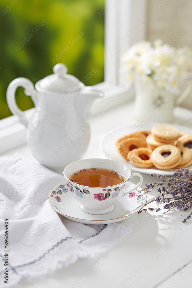 A cup of Lavender Tea with assorted biscuit A cup of Lavender Tea with assorted biscuit