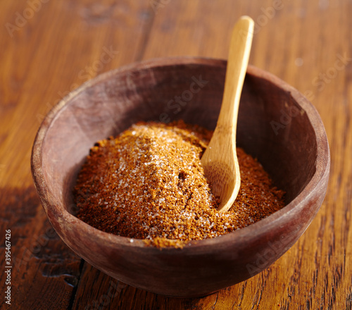 Jerk (seasoning mix, Caribbean) with a spoon in a wooden bowl