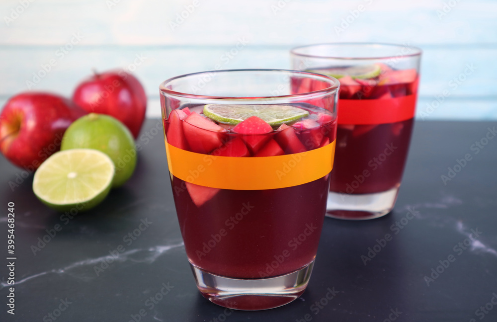 Closeup Chilled Red Wine Sangria on the Table with Blurry Fresh Fruits in the Background Closeup Chilled Red Wine Sangria on the Table with Blurry Fresh Fruits in the Background