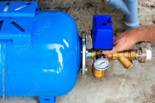 Photography installation of a water supply station to a residential building using a hydraulic accumulator