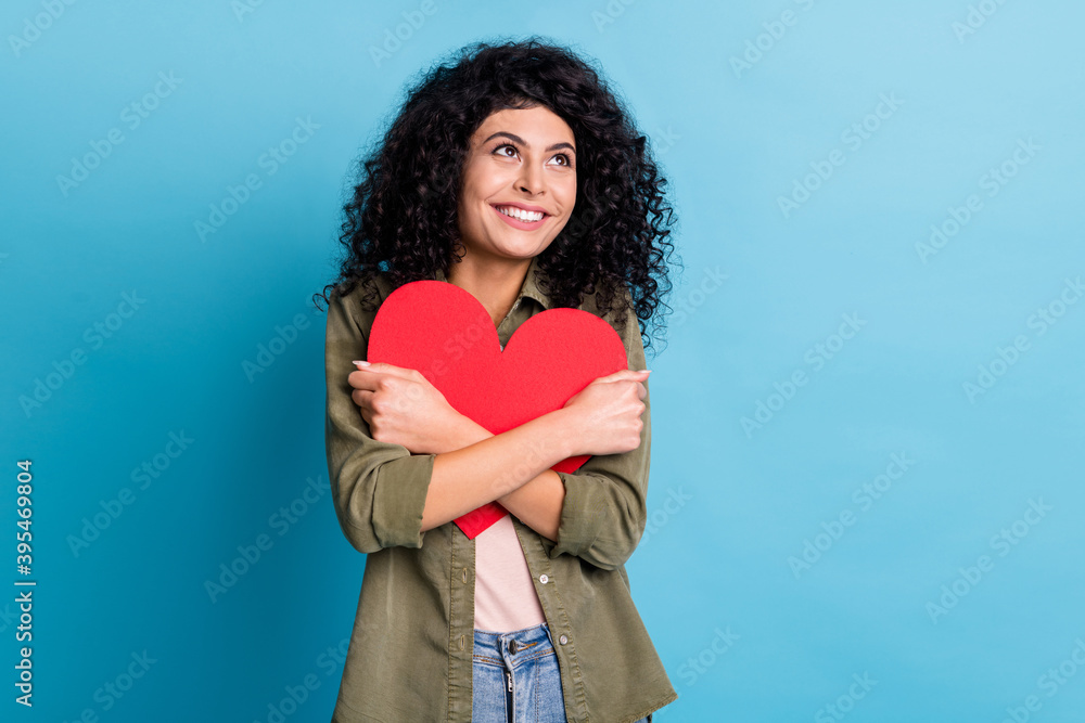 Photo of lovely charming person hands hold heart postcard look empty space isolated on blue color background Photo of lovely charming person hands hold heart postcard look empty space isolated on blue color background