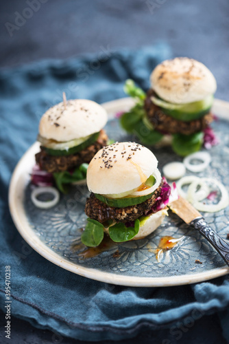 Vegan mini burgers with beluga lentil fritters, lamb's lettuce, radicchio, cucumber, onions and chilli sauce photo